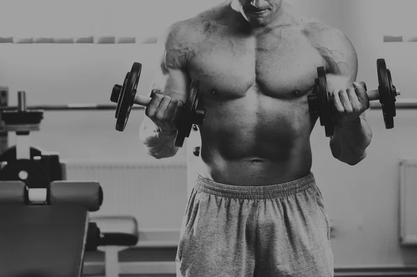 Strong muscular man on a treadmill. — Stock Photo, Image