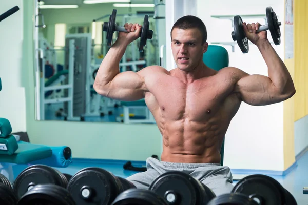 Knappe, atletische, zelfverzekerd man in de sportschool. Bodybuilding pose — Stockfoto