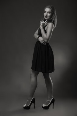 Karanlık bir arka plan üzerine bir güzel şık elbiseli baştan çıkarıcı esmer.