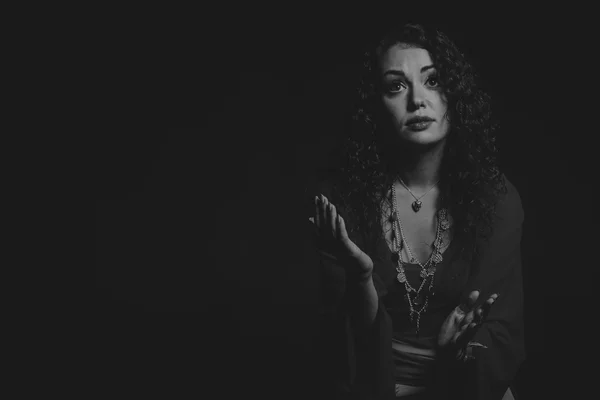 Beautiful, mysterious, cute brunette on a dark background. — Stock Photo, Image