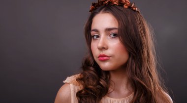 Bir çelenk karanlık bir arka plan üzerinde güzel kız. yakın çekim portre. Güzellik fotoğraf