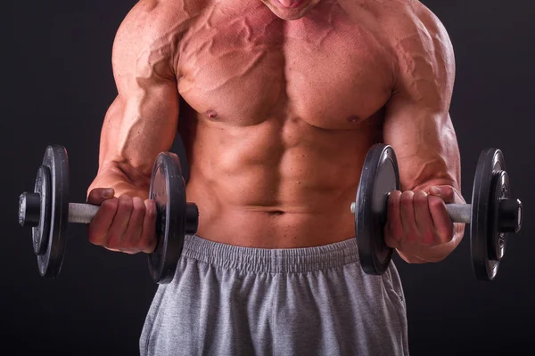 Farklı poz vücut geliştirmeci onların kas gösteren teşkil etmektedir. Karanlık bir arka plan üzerinde hata oluştu. Erkek gösteren kaslar zorlayarak. Güzel kas vücut atlet.