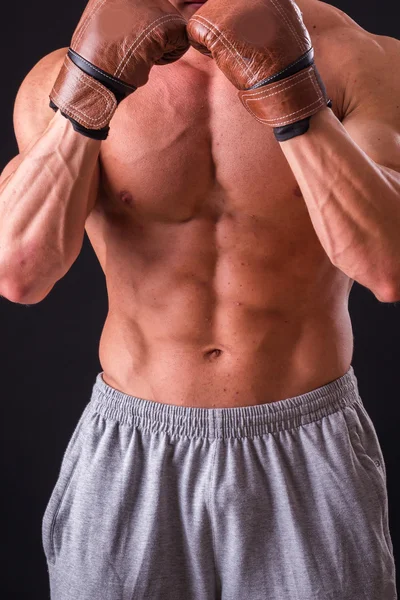 Man with boxing gloves on a black background — Stock Photo, Image