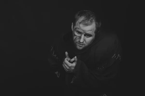 Hermoso y fascinante actor de teatro de juego en cámara. Foto en blanco y negro del actor disfrazado de mendigo sobre un fondo oscuro. Imagen escénica bellamente decorada y maquillaje profesional . — Foto de Stock