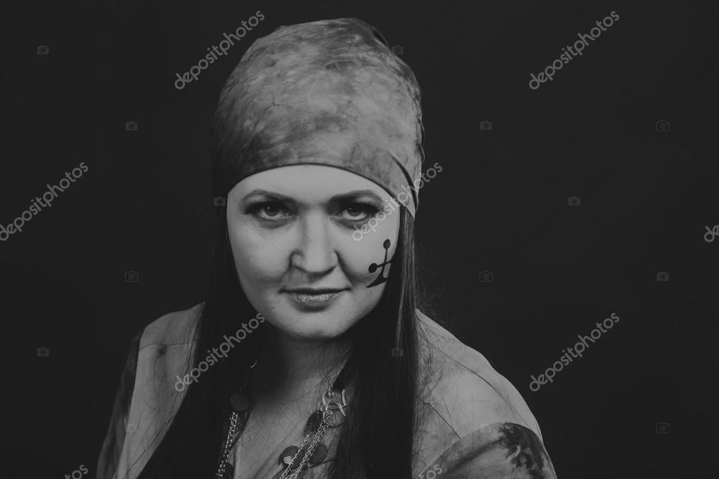 Beautiful gypsy girl on a black background, black and white photo Stock