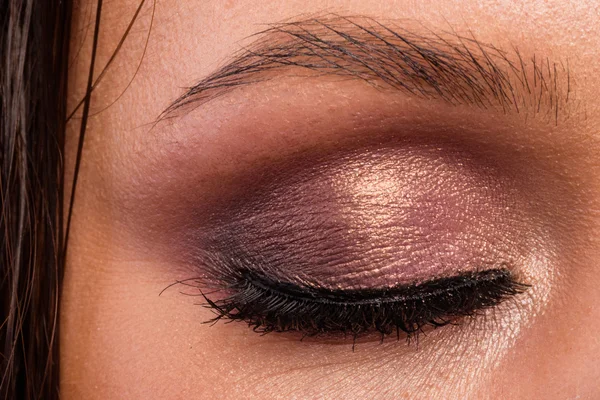 Grandes ojos de maquillaje profesional. Brillo, sombra de ojos, iluminador, delineador de ojos. Ojo de niña primer plano . — Foto de Stock