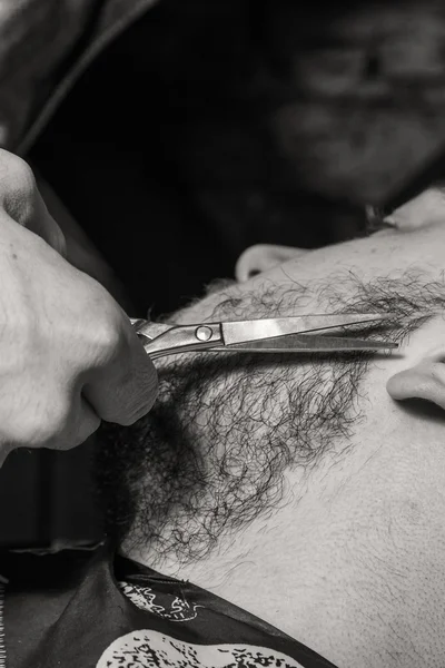 Haircut men Barbershop. Men\'s Hairdressers; barbers. Barber cuts client with scissors.