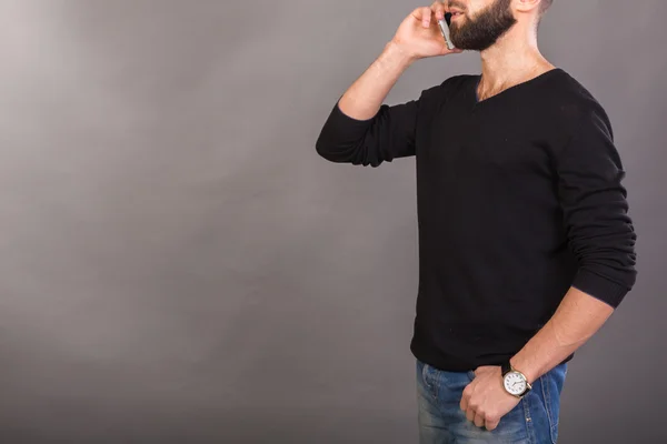 Young successful man talking on a mobile phone — Stock Photo, Image