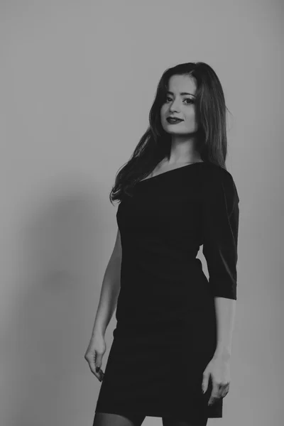 Schöne romantische Bild eines Mädchens i. schöne Brünette in einem stilvollen Kleid auf einem dunklen Hintergrund. professionelles Make-up und Schmuckdesign. Foto für Modemagazine, Poster und Webseiten. — Stockfoto