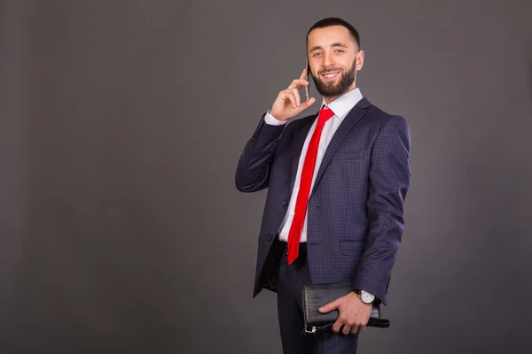 Fiatal üzletember. Egy ember, egy szép öltöny, fehér ing, nyakkendő vörös. — Stock Fotó
