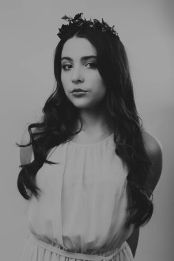 Karanlık bir arka plan üzerinde güzel, gizemli, şirin esmer. Siyah ve beyaz fotoğraf güzel gizemli esmer.