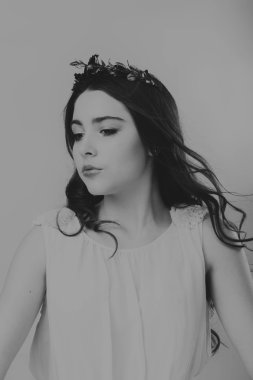 Karanlık bir arka plan üzerinde güzel, gizemli, şirin esmer. Siyah ve beyaz fotoğraf güzel gizemli esmer.