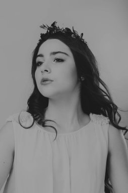 Karanlık bir arka plan üzerinde güzel, gizemli, şirin esmer. Siyah ve beyaz fotoğraf güzel gizemli esmer.