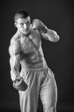 Boks eldivenleri adam. Siyah arka plan üzerinde genç boksör savaşçısı. Savaşmaya hazır boksörü. Boks, egzersiz, kas, güç, güç - eğitim ve boks gücü kavramı