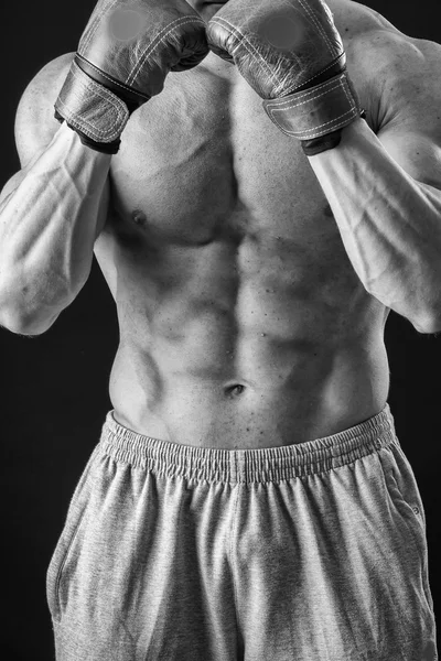 The man in boxing gloves. Young Boxer fighter over black background. Boxing man ready to fight. Boxing, workout, muscle, strength, power - the concept of strength training and boxing — Stock Photo, Image