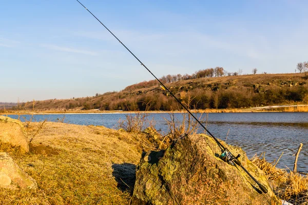 Fishing spinning on the background gorgeous landscape on the river — Stock Photo, Image