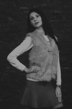 Karanlık bir arka plan üzerinde güzel, gizemli, şirin esmer. Siyah ve beyaz fotoğraf güzel gizemli esmer.