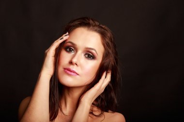 Karanlık bir arka plan üzerinde güzel, gizemli, şirin esmer. Siyah ve beyaz fotoğraf güzel gizemli esmer.