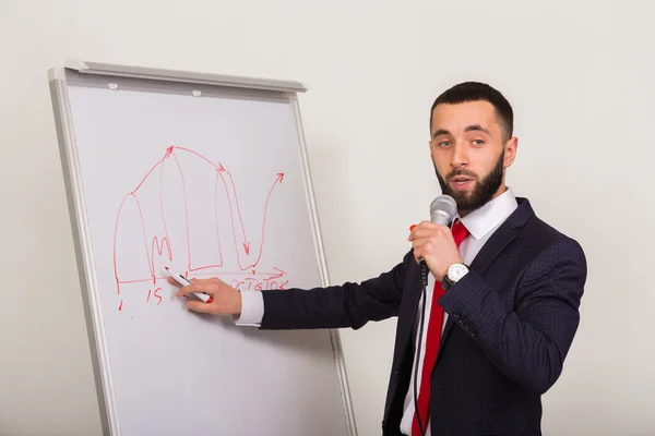 Business coach writes on the blackboard marker — Stock Photo, Image