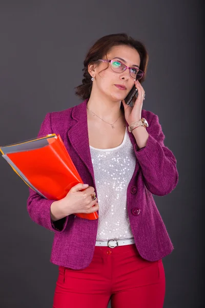 Business girl with a folder for papers and telephone — Stock Photo, Image