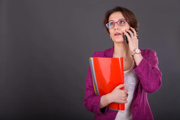 Business girl with a folder for papers and telephone — Stock Photo, Image