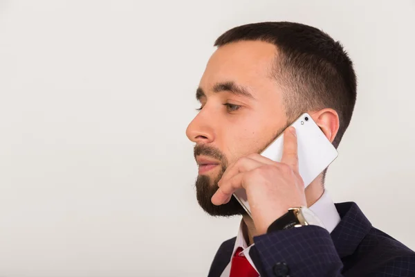 Mobile phone in the hands of a young businessman — Stock Photo, Image