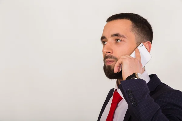 Mobile phone in the hands of a young businessman — Stock Photo, Image