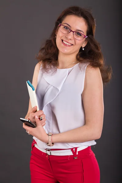 Business girl with a folder for papers and telephone — Stock Photo, Image