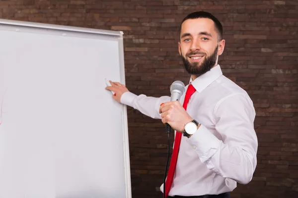 Business coach writes on the blackboard marker — Stock Photo, Image