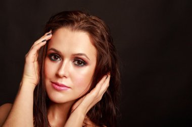 Karanlık bir arka plan üzerinde güzel, gizemli, şirin esmer. Siyah ve beyaz fotoğraf güzel gizemli esmer.