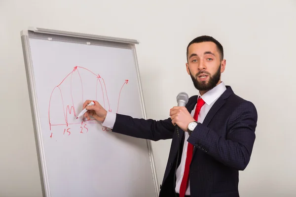 Business coach writes on the blackboard marker — Stock Photo, Image