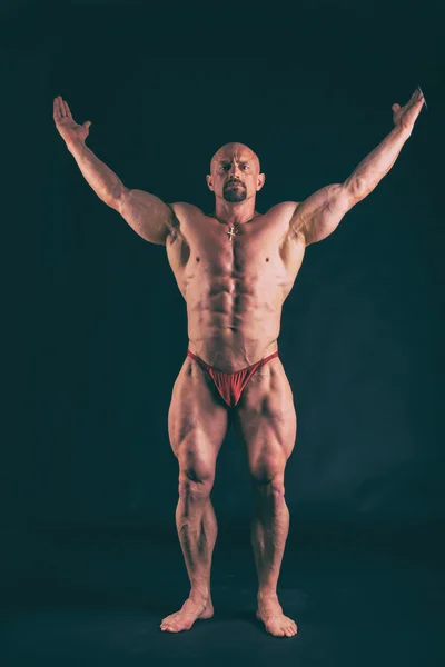 Big bodybuilder on a dark background — Stock Photo, Image