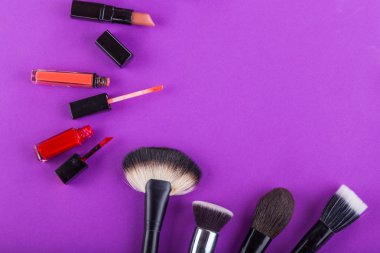 Fırçalar ve diğer araçları makyaj mor bir arka plan üzerinde