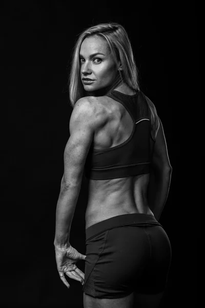 Fitness girl posing on black — Stock Photo, Image