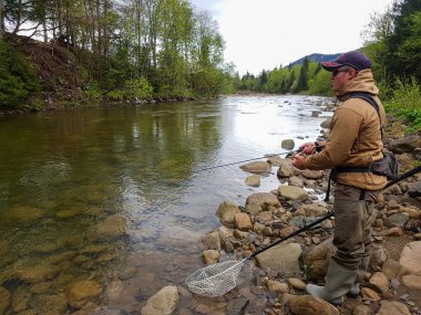 Dağ Nehri üzerinde Balık tutma. Kıyıdaki balıkçı. Yaz Ac