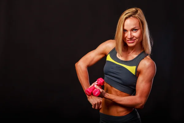 Fitness girl posing on black — Stock Photo, Image