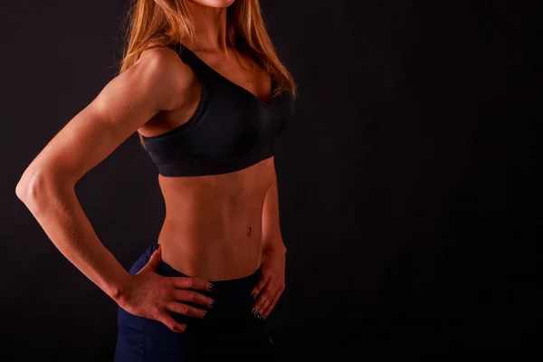 Fitness girl posing on black — Stock Photo, Image