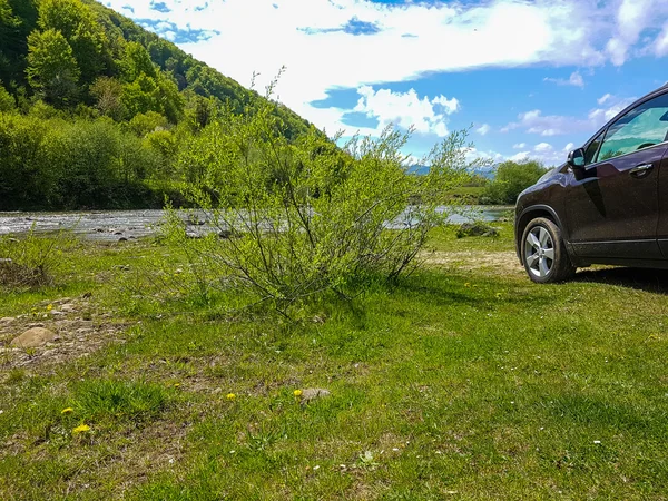Bil nära floden. bergen i bakgrunden — Stockfoto