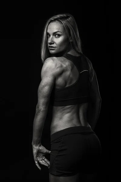 Woman bodybuilder on black — Stock Photo, Image