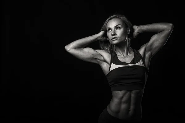 Woman bodybuilder on black