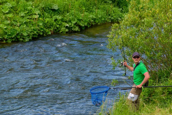 Рыбак быстро ловит рыбу в реке — стоковое фото