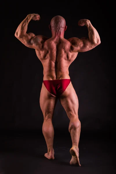 Big bodybuilder on black — Stock Photo, Image