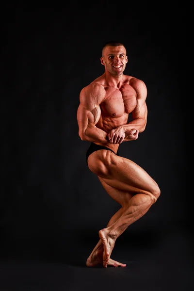 Big bodybuilder on black — Stock Photo, Image