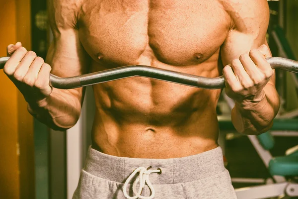 A man with a barbell exercise on biceps — Stock Photo, Image