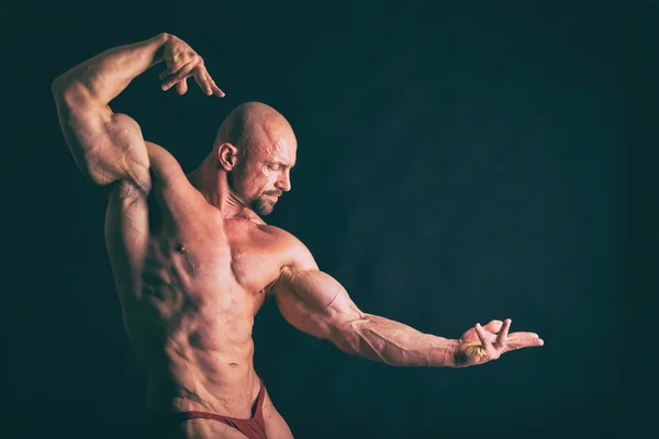 Muscular man on black — Stock Photo, Image