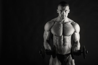 Bodybuilder posing in different poses demonstrating their muscles. Failure on a dark background. Male showing muscles straining. Beautiful muscular body athlete. clipart