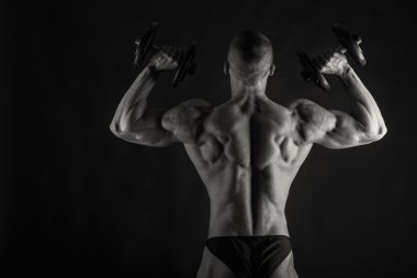 Farklı poz vücut geliştirmeci onların kas gösteren teşkil etmektedir. Karanlık bir arka plan üzerinde hata oluştu. Erkek gösteren kaslar zorlayarak. Güzel kas vücut atlet.