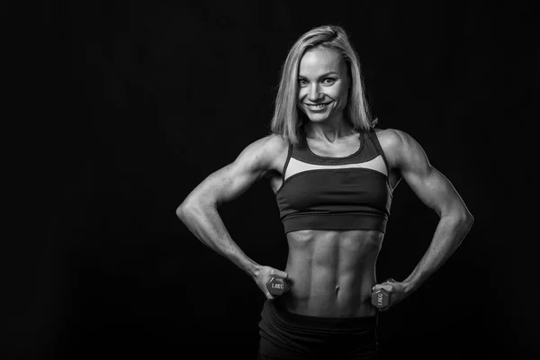 Fitness menina bonita posando em um fundo preto . — Fotografia de Stock