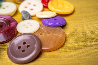 Kumaştan yapılmış bir arkaplanda farklı düğmeler