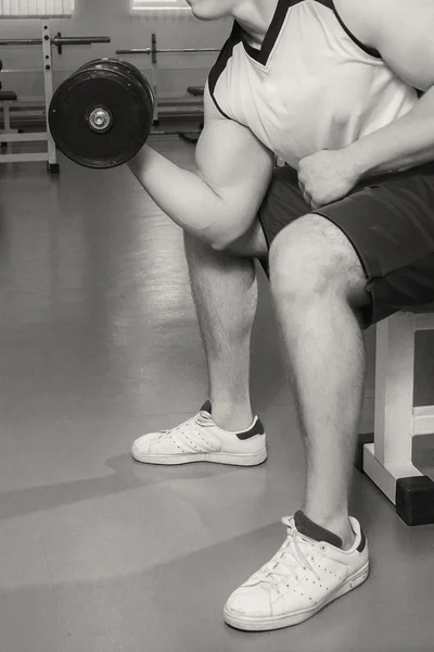 Man makes exercises with dumbbells. — Stock Photo, Image